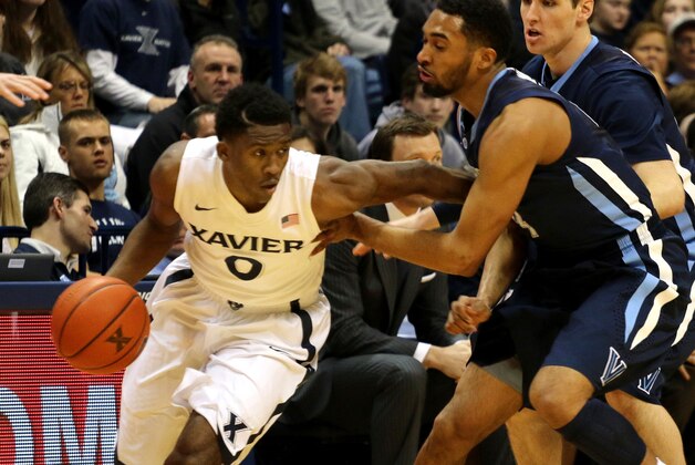 Xavier's Semaj Christon tries to get past Villanova's Darrun Hilliard in the first half of their NCAA college basketball game in Cincinnati Thursday March 6, 2014. (AP Photo/Tom Uhlman)