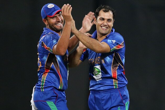 SHARJAH, UNITED ARAB EMIRATES - DECEMBER 08: Merwais Ashraf (L) and Mohammad Nabi Eisakhil (R) celebrate during the Twenty20 match between Afghanistan and Pakistan at the Sharjah Cricket Stadium on December 8, 2013 in Sharjah, United Arab Emirates. (Photo by Francois Nel/Getty Images) SHARJAH, UNITED ARAB EMIRATES - DECEMBER 08: Merwais Ashraf (L) and Mohammad Nabi Eisakhil (R) celebrate during the Twenty20 match between Afghanistan and Pakistan at the Sharjah Cricket Stadium on December 8, 2013 in Sharjah, United Arab Emirates. (Photo by Francois Nel/Getty Images)