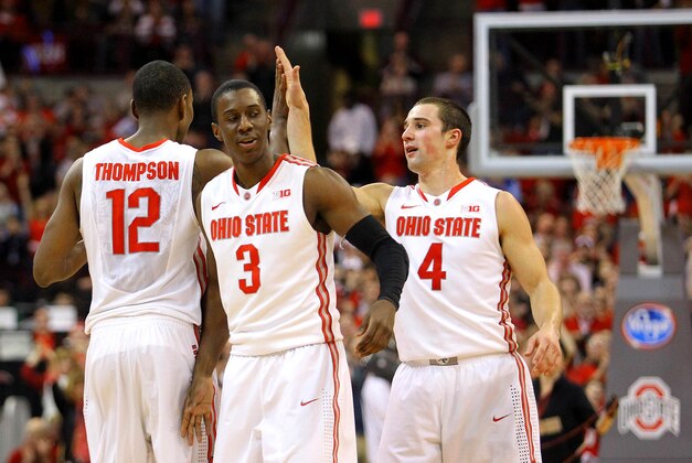 Feb 22, 2014; Columbus, OH, USA;  Ohio State Buckeyes Sam Thompson (12) Shannon Scott (3) and Aaron Craft (4) celebrate after an alleyoop play during the second half of the game against the Minnesota Golden Gophers at Schottenstein Center. Mandatory Credit: Rob Leifheit-USA TODAY Sports
