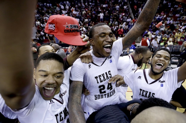 Texas Southern players Lawrence Johnson-Danner, left, Aaric Murray (24) and D'Angelo Scott, right, celebrate after beating Prairie View A&M in an NCAA college basketball game in the championship of the Southwestern Athletic Conference tournament Saturday, March 15, 2014, in Houston. Texas Southern won 78-73. (AP Photo/David J. Phillip)
