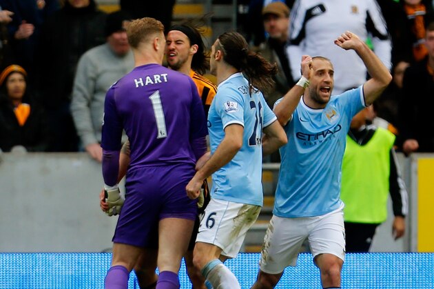 HULL, ENGLAND - MARCH 15:  Goalkeeper Joe Hart of Manchester City and George Boyd of Hull City clash following a penalty area incident during the Barclays Premier league match between Hull City and Manchester City at KC Stadium on March 15, 2014 in Hull, England.  (Photo by Paul Thomas/Getty Images)