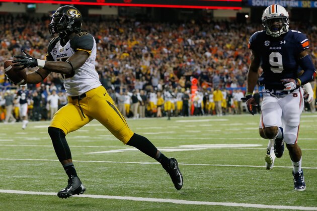 ATLANTA, GA - DECEMBER 07:  Dorial Green-Beckham #15 of the Missouri Tigers scores a touchdown in the second quarter against Jermaine Whitehead #9 of the Auburn Tigers during the SEC Championship Game at Georgia Dome on December 7, 2013 in Atlanta, Georgia.  (Photo by Kevin C. Cox/Getty Images)