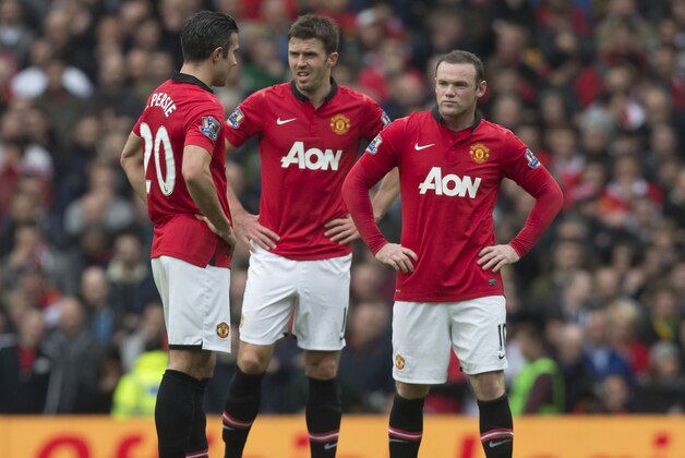 Manchester United's Wayne Rooney, right, Michael Carrick, centre, and Robin van Persie wait for play to restart after Liverpool's first goal during their English Premier League soccer match at Old Trafford Stadium, Manchester, England, Sunday March 16, 2014. Liverpool won the game 3-0. (AP Photo/Jon Super) Manchester United's Wayne Rooney, right, Michael Carrick, centre, and Robin van Persie wait for play to restart after Liverpool's first goal during their English Premier League soccer match at Old Trafford Stadium, Manchester, England, Sunday March 16, 2014. Liverpool won the game 3-0. (AP Photo/Jon Super)