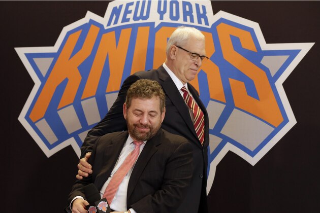 New York Knicks new team president Phil Jackson puts his hand on team owner James Dolan, seated, during a news conference where Jackson was introduced, at New York's Madison Square Garden, Tuesday, March 18, 2014. Jackson signed a five-year contract that will reportedly pay him at least $12 million annually and said he will spend significant time in New York. (AP Photo/Richard Drew) New York Knicks new team president Phil Jackson puts his hand on team owner James Dolan, seated, during a news conference where Jackson was introduced, at New York's Madison Square Garden, Tuesday, March 18, 2014. Jackson signed a five-year contract that will reportedly pay him at least $12 million annually and said he will spend significant time in New York. (AP Photo/Richard Drew)