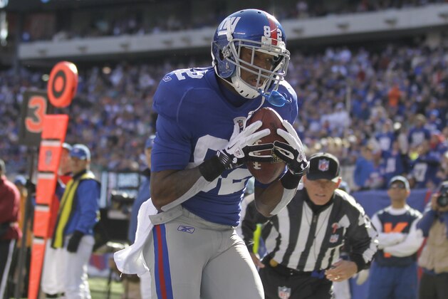 New York Giants wide receiver Mario Manningham (82) catches a pass for a touchdown during the second quarter of an NFL football game against the Miami Dolphins Sunday, Oct. 30, 2011 in East Rutherford, N.J. (AP Photo/Julio Cortez)