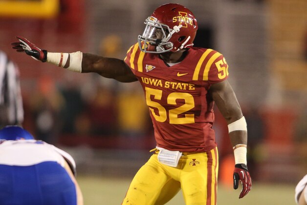 Iowa State linebacker Jeremiah George (52) gives directions to another Iowa State defensive player during the second half of an NCAA college football game against Kansas in Ames, Iowa, Saturday, Nov. 23, 2013. Iowa State won 34-0. (AP Photo/Justin Hayworth)