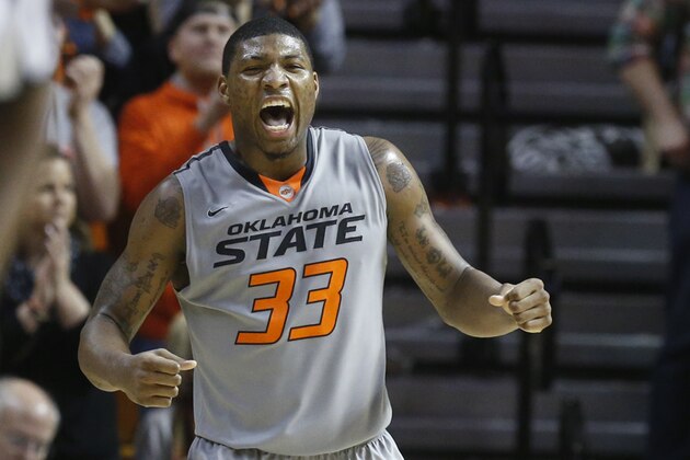 Oklahoma State guard Marcus Smart (33) celebrates during the second half of an NCAA college basketball game against Kansas in Stillwater, Okla., Saturday, March 1, 2014. Oklahoma State won 72-65. (AP Photo/Sue Ogrocki)