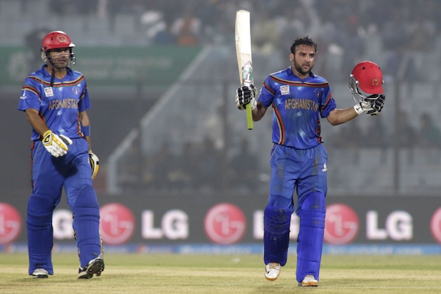 Afghanistan cricketers Shafiqullah, right and captain Mohammad Nabi celebrate their victory over Hong Kong during their ICC Twenty20 Cricket World Cup match in Chittagong, Bangladesh, Tuesday, March 18, 2014. Afghanistan won by seven wickets.(AP Photo/Bikas Das)