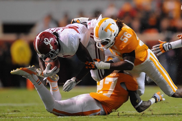 Oct 20, 2012; Knoxville, TN, USA; Alabama Crimson Tide running back Eddie Lacy (42) is tackled by Tennessee Volunteers defensive back Justin Coleman (27) and linebacker Curt Maggitt (56) during the first half at Neyland Stadium. Mandatory Credit: Randy Sartin-USA TODAY Sports