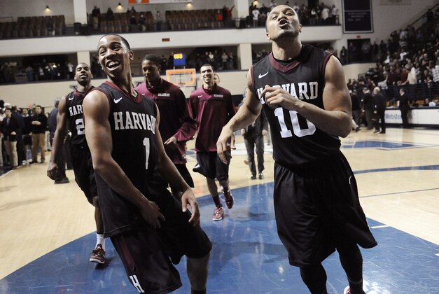 Harvard's Siyani Chambers, left, and Brandyn Curry, right, celebrate their 70-58 win over Yale at the end of an NCAA college basketball game, Friday, March 7, 2014, in New Haven, Conn. (AP Photo/Jessica Hill)