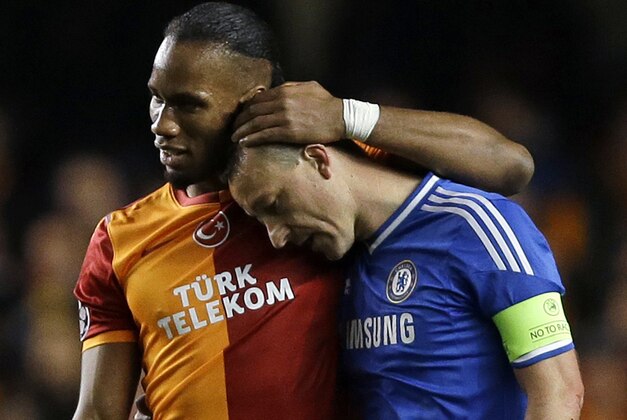Galatasaray's Didier Drogba, left, embraces Chelsea's John Terry at the end of the Champions League round of 16 second leg soccer match between Chelsea and Galatasaray at Stamford Bridge stadium  in London Tuesday, March 18, 2014. (AP Photo/Kirsty Wigglesworth)
