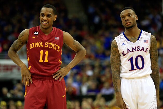 KANSAS CITY, MO - MARCH 14:  Monte Morris #11 of the Iowa State Cyclones smiles as he stands next to a dejected Naadir Tharpe #10 of the Kansas Jayhawks during the Big 12 Basketball Tournament semifinal game at Sprint Center on March 14, 2014 in Kansas City, Missouri.  (Photo by Jamie Squire/Getty Images)