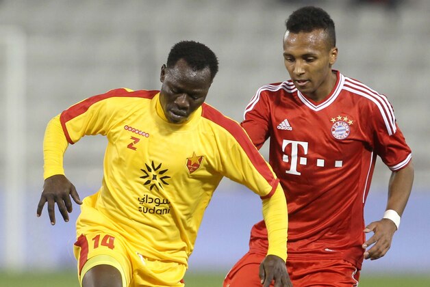 Bayern Munich's Julian Green, right, of Munich and Balla Jabir of Al-Merrikh, challenge for the ball,  during their friendly soccer match, at Al-Saad stadium in Doha Thursday, Jan. 9, 2014. (AP Photo/Osama Faisal)