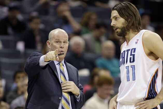 Charlotte Bobcats' head coach Steve Clifford makes a point with player Josh McRoberts (11) against the Atlanta Hawks during the first half of an NBA basketball game in Charlotte, N.C., Monday, March 17, 2014. (AP Photo/Bob Leverone)