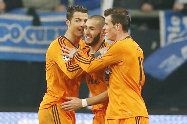 Real's Cristiano Ronaldo, Real's Karim Benzema and Real's Gareth Bale, from left, celebrate their team's fourth goal during the Champions League round of the last 16 first leg soccer match between Schalke 04 and Real Madrid in Gelsenkirchen, Germany, Wednesday, Feb.26,2014. (AP Photo/Frank Augstein)