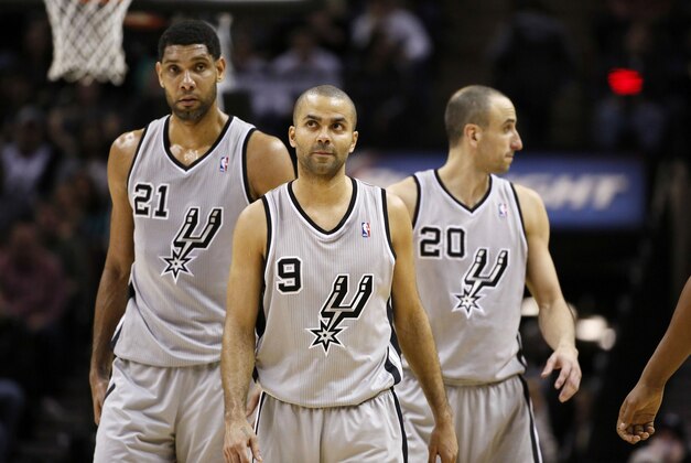 Jan 17, 2014; San Antonio, TX, USA; San Antonio Spurs players Tim Duncan (21) and Tony Parker (9) and Manu Ginobili (20) react during the second half against the Portland Trail Blazers at AT&T Center. The Blazers won 109-100. Mandatory Credit: Soobum Im-USA TODAY Sports