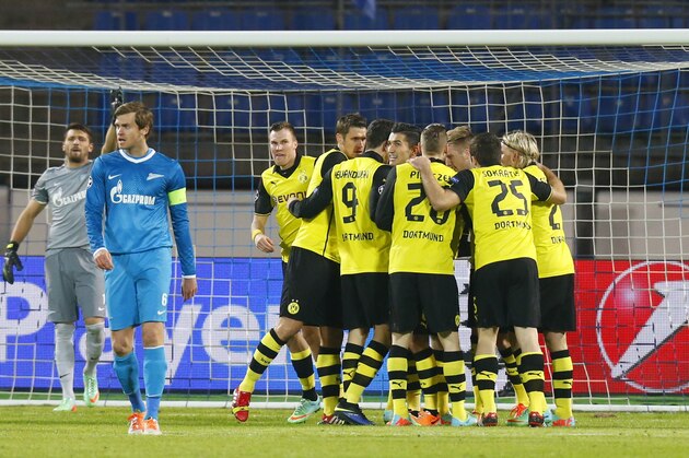 Borussia team players celebrate their opening goal against Zenit during the Champions League soccer match between Zenit St.Petersburg and  Borussia Dortmund at Petrovsky stadium in St.Petersburg, Russia, on Tuesday, Feb. 25, 2014. (AP Photo/Dmitry Lovetsky)