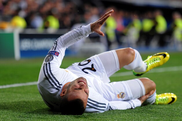 MADRID, SPAIN - MARCH 18:  Jese of Real Madrid goes down under a heavy tackle from Sead Kolasinac of Schalke during the UEFA Champions League Round of 16, second leg match between Real Madrid and FC Schalke 04 at Estadio Santiago Bernabeu on March 18, 2014 in Madrid, Spain.  (Photo by Denis Doyle/Getty Images)