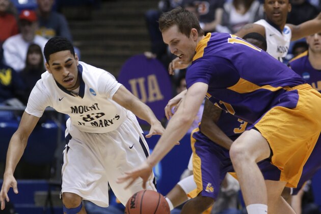 Mount St. Mary's guard Julian Norfleet, left, and Albany forward Luke Devlin chase a loose ball in the first half of a first-round game of the NCAA college basketball tournament, Tuesday, March 18, 2014, in Dayton, Ohio. (AP Photo/Al Behrman)