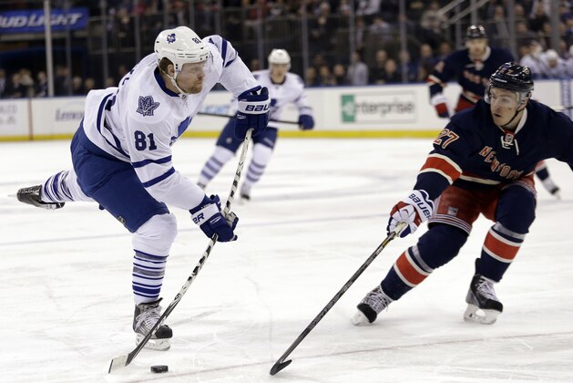 Toronto Maple Leafs' Phil Kessel (81) shoots the puck past New York Rangers' Ryan McDonagh (27) during the first period of an NHL hockey game Wednesday, March 5, 2014, in New York. (AP Photo/Frank Franklin II)