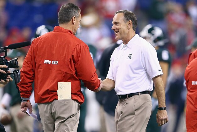 INDIANAPOLIS, IN - DECEMBER 07:  Urban Meyer the head coach of the Ohio State Buckeyes and Mark Dantonio the head coach of the Michigan State Spartans talk before the Big Ten Championship at Lucas Oil Stadium on December 7, 2013 in Indianapolis, Indiana.  (Photo by Andy Lyons/Getty Images)