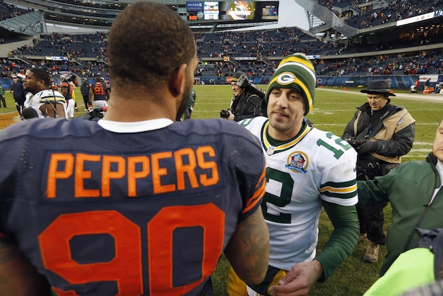 Green Bay Packers quarterback Aaron Rodgers (12) and Chicago Bears defensive end Julius Peppers (90) meet after their NFL football game in Chicago, Sunday, Dec. 16, 2012. The Packers won 21-13 to clinch the NFC North division title. (AP Photo/Charles Rex Arbogast) Green Bay Packers quarterback Aaron Rodgers (12) and Chicago Bears defensive end Julius Peppers (90) meet after their NFL football game in Chicago, Sunday, Dec. 16, 2012. The Packers won 21-13 to clinch the NFC North division title. (AP Photo/Charles Rex Arbogast)