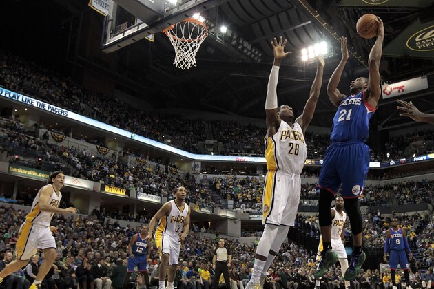 Philadelphia 76ers forward Thaddeus Young (21) shoots over Indiana Pacers center Ian Mahinmi (28) during the first half of an NBA basketball game in Indianapolis, Monday, March 17, 2014. (AP Photo/AJ Mast)