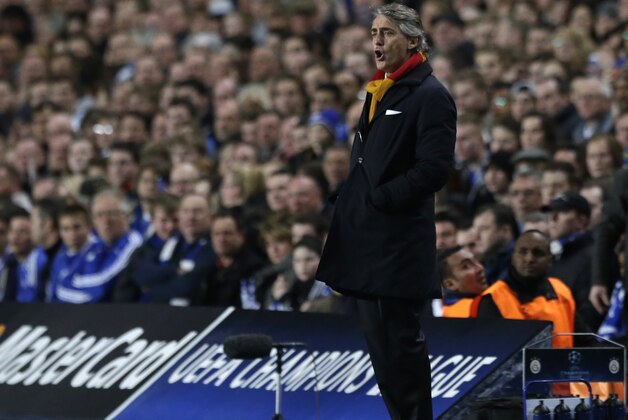 Galatasaray's head coach Roberto Mancini watches his side from the technical area during the Champions League last 16 second leg soccer match between Chelsea and Galatasaray at Stamford Bridge stadium in London, Tuesday, March 18, 2014. (AP Photo/Matt Dunham)