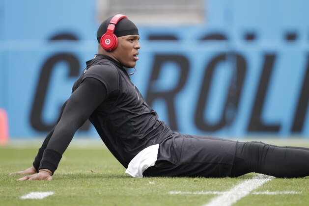Carolina Panthers' Cam Newton stretches before an NFL football game against the New Orleans Saints in Charlotte, N.C., Sunday, Dec. 22, 2013. (AP Photo/Bob Leverone)