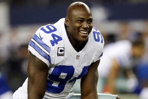 FILE - In this Oct. 13, 2013, file photo, Dallas Cowboys defensive end DeMarcus Ware talks with teammates while stretching during warm ups before an NFL football game against the Washington Redskins in Arlington, Texas. The Broncos kept their free agency focus on defense as they agreed to a three-year deal with Ware, according to a person with knowledge of the situation. (AP Photo/Tim Sharp, File)