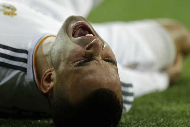 Real's Jese Rodriguez cries out in pain during a Champions League last 16 second leg soccer match between Real Madrid and Schalke 04 at the Santiago Bernabeu stadium in Madrid, Spain, Tuesday March 18, 2014. (AP Photo/Paul White)