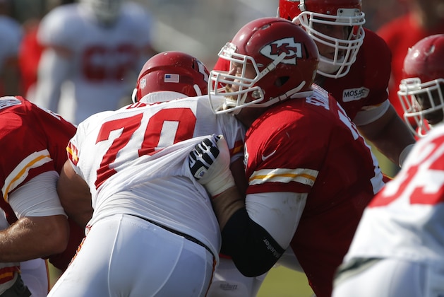 Kansas City Chiefs tackle Geoff Schwartz (74) and defensive end Mike DeVito (70) during NFL football training camp in St. Joseph, Mo., Thursday, Aug. 1, 2013. (AP Photo/Orlin Wagner)