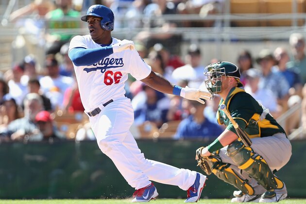 GLENDALE, AZ - MARCH 10:  Yasiel Puig #66 of the Los Angeles Dodgers bats against the Oakland Athletics during the spring training game at Camelback Ranch on March 10, 2014 in Glendale, Arizona.  (Photo by Christian Petersen/Getty Images)