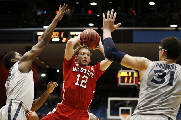 DAYTON, OH - MARCH 18:  Tyler Lewis #12 of the North Carolina State Wolfpack looks to pass against Semaj Christon #0 and Isaiah Philmore #31 of the Xavier Musketeers in the second half during the first round of the 2014 NCAA Men's Basketball Tournament at at University of Dayton Arena on March 18, 2014 in Dayton, Ohio.  (Photo by Gregory Shamus/Getty Images)