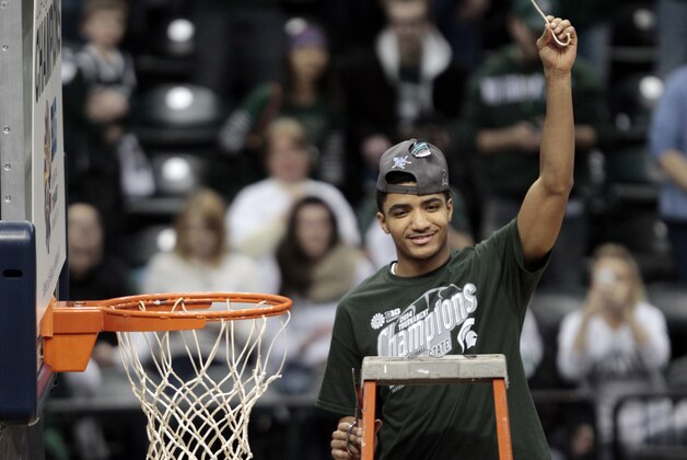 Michigan State guard Gary Harris holds up a piece of the net after his team defeated Michigan 69-55 in an NCAA college basketball game in the championship of the Big Ten Conference tournament on Sunday, March 16, 2014, in Indianapolis. (AP Photo/AJ Mast)