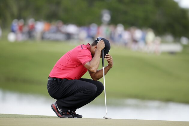 Tiger Woods bows his head on the fourth green during the final round of the Cadillac Championship golf tournament on Sunday, March 9, 2014, in Doral, Fla. Woods made bogey on the hole. (AP Photo/Lynne Sladky)