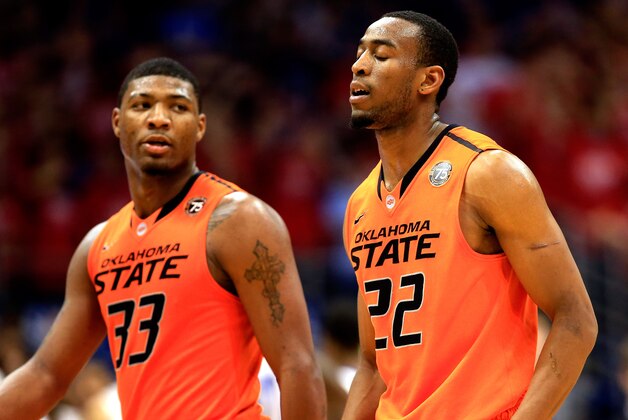 LAWRENCE, KS - JANUARY 18:  Marcus Smart #33 and Markel Brown #22 of the Oklahoma State Cowboys walk off the court during a timeout in the game against the Kansas Jayhawks at Allen Fieldhouse on January 18, 2014 in Lawrence, Kansas.  (Photo by Jamie Squire/Getty Images)