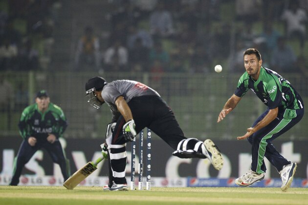 United Arab Emirates's Faizan Asif, center, runs to make his ground, as Ireland's Max Sorensen. right, waits to collect the ball during their ICC Twenty20 Cricket World Cup match in Sylhet, Bangladesh, Wednesday, March 19, 2014. (AP Photo/A.M. Ahad)