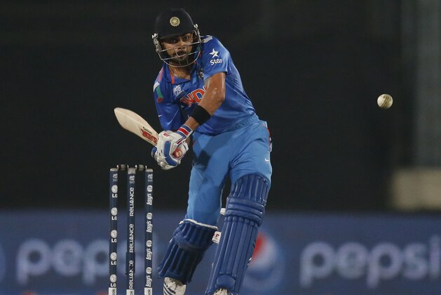 India's batsman Virat Kohli prepares to play a shot during their ICC Twenty20 Cricket World Cup warm up match against England in Dhaka, Bangladesh, Wednesday, March 19, 2014. (AP Photo/Aijaz Rahi)