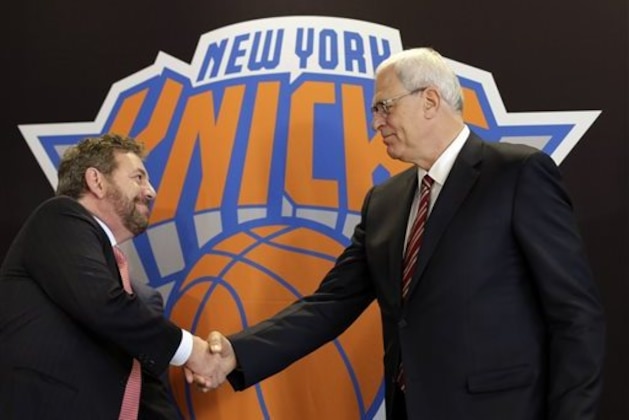 New York Knicks new team president Phil Jackson, right, shakes hands with Madison Square Garden Chairman James Dolan during a news conference where he was introduced, at New York's Madison Square Garden, Tuesday, March 18, 2014. (AP Photo/Richard Drew)