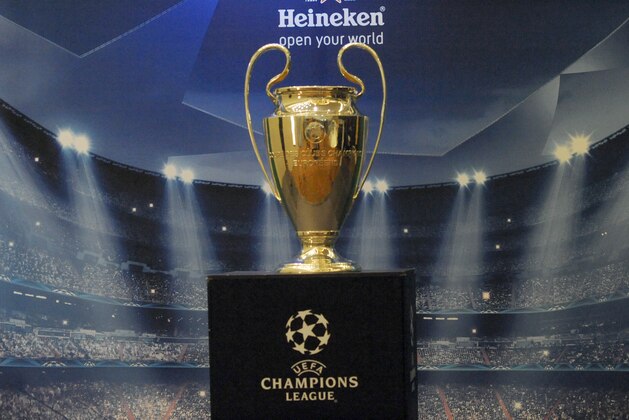 LAGOS, NIGERIA - MARCH 15: UEFA Trophy displayed for public viewing at Eko Hotel on March 15, 2014 in Lagos, Nigeria.  Football fans were given the opportunity to visit with the Heineken UEFA Champions League Trophy which began a three-nation tour in Nigeria under the auspices of Champions League partner, Heineken. Fans took photographs with the brand ambassador, former Real Madrid and ex-international football star Christian Karembeu.  (Photo by Pius Utomi Ekpei/Getty Images)