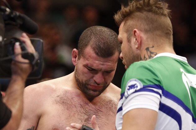 Mauricio 'Shogun' Rua is consoled by his cornerman after losing to Chael Sonnen in their UFC on Fox Sports 1 mixed martial arts light heavyweight bout in Boston, Saturday, August 17,2013.  Sonnen won via first round tapout via guillotine choke. (AP Photo/Gregory Payan)