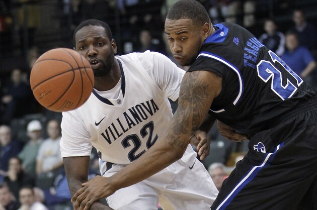 Villanova's JayVaughn Pinkston (22) passes the ball around Seton Hall's Eugene Teague (21) during the first half of an NCAA college basketball game, Friday, Feb. 7, 2014, in Villanova, Pa. (AP Photo/Laurence Kesterson)