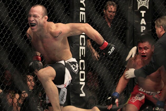 Wanderlei Silva, left, celebrates after beating Cung Le, right, during the second round of a UFC 139 Mixed Martial Arts middleweight bout in San Jose, Calif., Saturday, Nov. 19, 2011. Silva won by TKO in the second round. (AP Photo/Jeff Chiu)