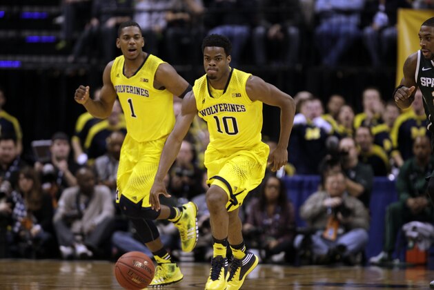 Michigan guard Derrick Walton Jr. (10) drives against Michigan State in the first half of an NCAA college basketball game in the championship of the Big Ten Conference tournament Sunday, March 16, 2014, in Indianapolis. (AP Photo/Kiichiro Sato)