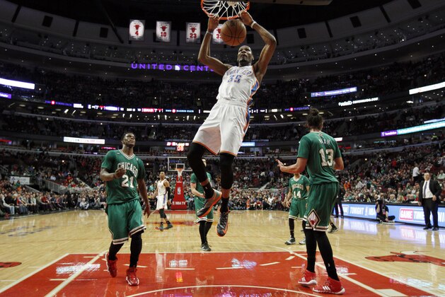 Oklahoma City Thunder forward Kevin Durant (35) dunks between Chicago Bulls guard Jimmy Butler (21) and Joakim Noah (13) during the second half of an NBA basketball game Monday, March 17, 2014, in Chicago.  The Thunder won the game 97-85. (AP Photo/Jeff Haynes)