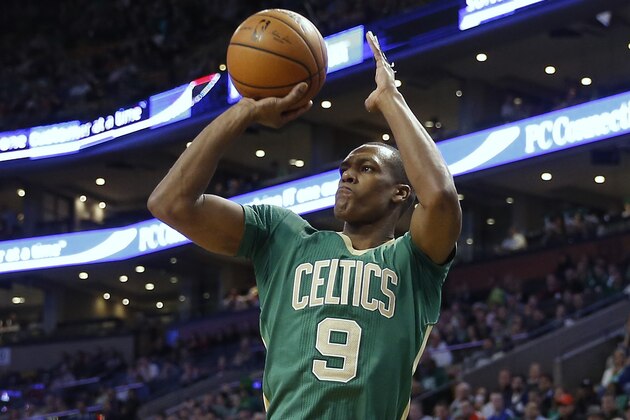 Boston Celtics guard Rajon Rondo shoots against the Phoenix Suns during the first quarter of an NBA basketball game in Boston Friday, March 14, 2014. (AP Photo/Winslow Townson)