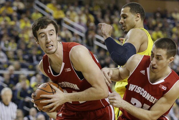 Wisconsin forward Frank Kaminsky (44) pulls down a rebound next to teammate guard Josh Gasser (21) during the first half of an NCAA college basketball game against Michigan in Ann Arbor, Mich., Sunday, Feb. 16, 2014. Kaminsky finished with 25 points in the Badgers 75-62 win. (AP Photo/Carlos Osorio)
