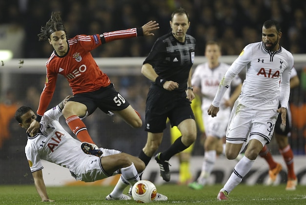 Benfica's Lazae Markovic leaps into the air as he vies for the ball with Tottenham's Sandro, right, during the Europa League round of 16 first leg soccer match between Tottenham Hotspur and SL Benfica at White Hart Lane stadium in London Thursday, March 13, 2014. (AP Photo/Kirsty Wigglesworth)