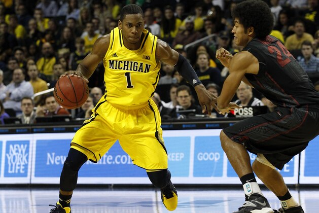 NEW YORK, NY - DECEMBER 21:  Glenn Robinson III #1 of the Michigan Wolverines drives against Josh Huestis #24 of the Stanford Cardinals during the Brooklyn Hoops Holiday Invitational at Barclays Center on December 21, 2013 in the Brooklyn borough of New York City. (Photo by Adam Hunger/Getty Images)